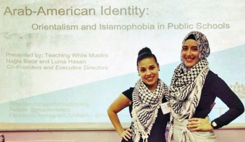 Nagla Bedir and Luma Hasan pose before their powerpoint presentation at a conference