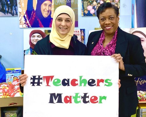 NEA President Becky Pringle and Hanan Al Hroub stand together holding a sign that says Teachers Matter