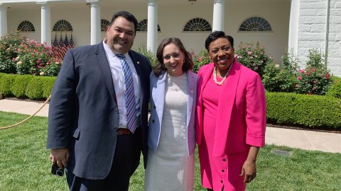 2023 National Teacher of the Year Rebecka Peterson stands in the White House Rose Garden with NEA President Becky Pringle and NEA Secretary-Treasurer Noel Candelaria