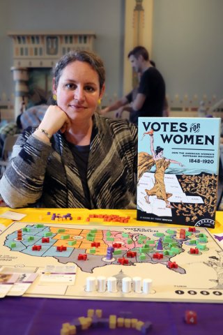 Tory Brown with a setup of her board game Votes for Women which features a USA map and game pieces
