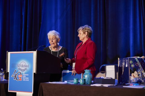 NEA-Retired President Sarah Borgman passes a gavel to NEA-Retired President-Elect Anita Gibson.