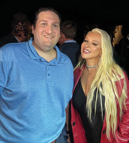 Music teacher Joe Bartell poses with Christina Aguilera at a fundraiser for proposition 28 in California