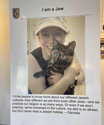 Photo of "I am a Jew" poster — young woman with cat