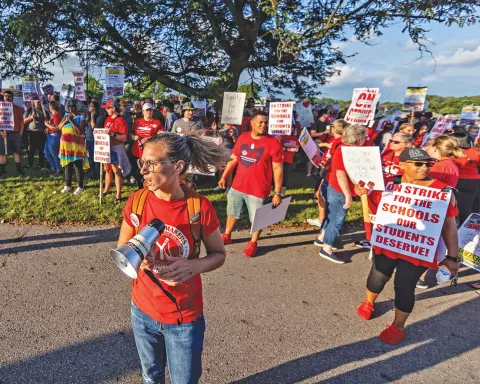 Columbus teacher Kelsey Gray, bullhorn in hand, rallies for better wages, and more